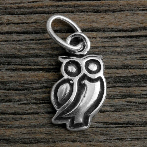 Sterling silver Owl Charm to add to any necklace or bracelet, shown on wood background