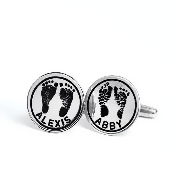 Sterling silver personalized cuff links with your kid's hand prints or footprints, shown on a white background, with Alexis and Abby names hand stamped on them