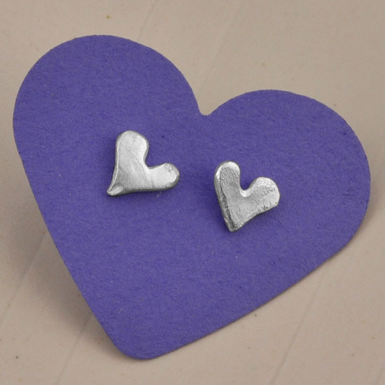 "Loved" fine silver heart earrings, shown with purple background