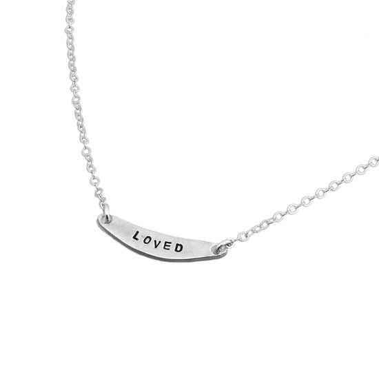 Mom necklace with fine silver arc charm, personalized with "LOVE" stamped on the charm, shown on white