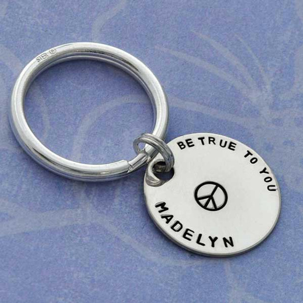 Silver custom hand stamped key ring for grandma with grandkids' names, shown on white