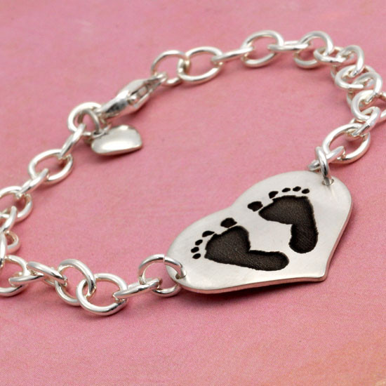 Side view of custom silver heart bracelet personalized with your child's actual footprints or handprints