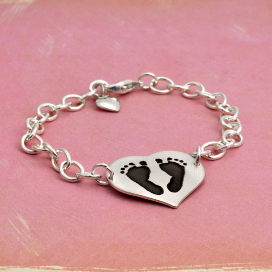 Side view of custom silver heart bracelet personalized with your child's actual footprints or handprints