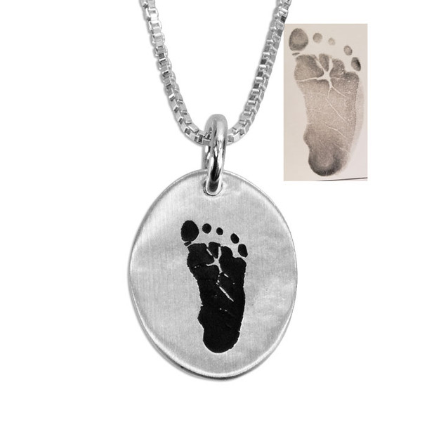 Fine silver custom handprint charm necklace, with original footprint used to personalize it, shown close up on white