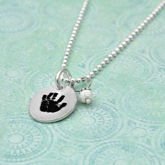 custom baby's handprint necklace in fine silver, with pearl, shown from side