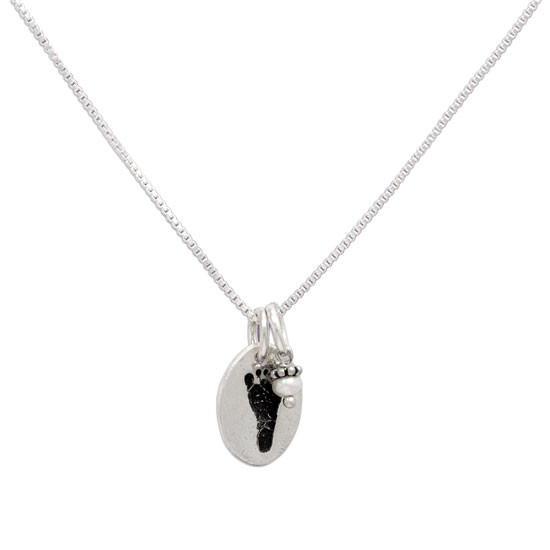 side view of fine silver custom footprint charm necklace, shown on white, with stone