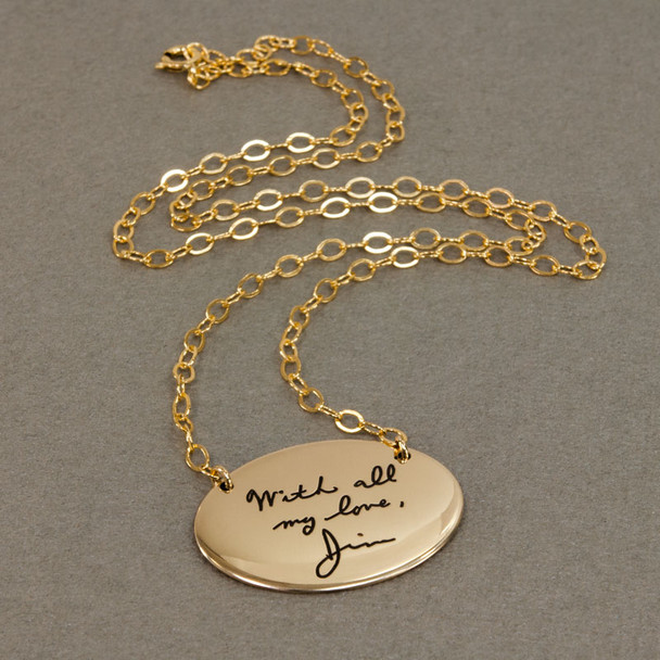Custom gold oval necklace with your actual handwriting, shown from the side
