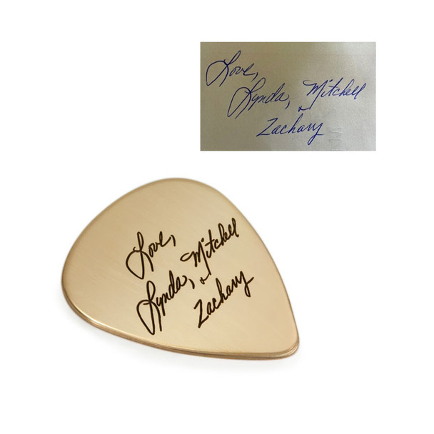 Custom gold guitar pick with loved one's actual handwritten signatures, shown on with original handwriting used to personalize the piece