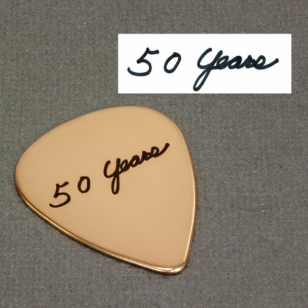 Anniversary present of gold guitar pick with wife's actual handwriting, shown on with original handwriting used to personalize the pick