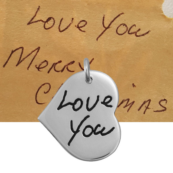 Silver Handwriting heart necklace on white with the words, Love You, and the original handwriting used to make the necklace
