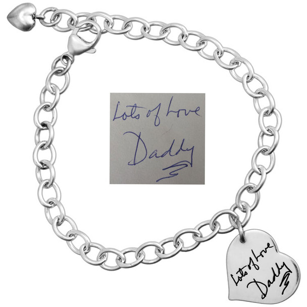 Custom small Silver Handwriting Heart Bracelet, engraved with Dad's handwritten signature, shown on white background with original handwritten note used to personalize it