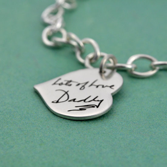 Side view silver heart bracelet with handwriting