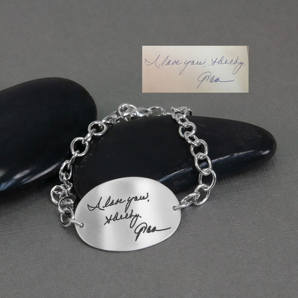 Large silver oval handwriting bracelet shown with the actual handwritten signature used to personalize the bracelet