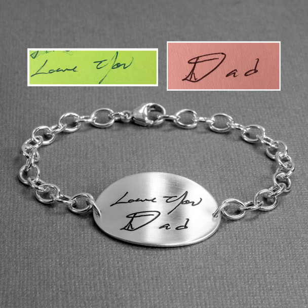 Large oval handwriting memorial bracelet showing actual handwriting & signature used to make the bracelet, shown from the side on gray