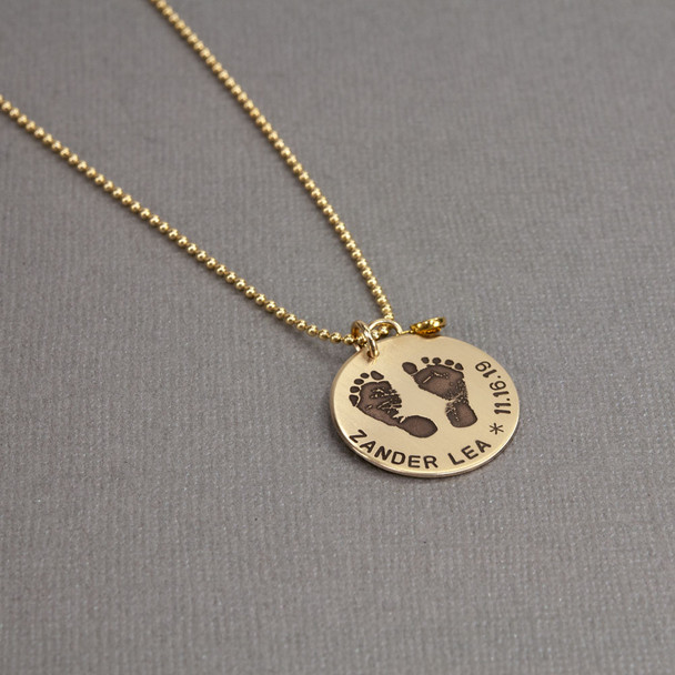Custom footprints necklace in gold with hand stamping & birthstone, shown from the side