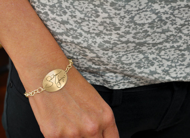 Model wearing  Custom Gold Oval Handwriting Bracelet, personalize with husband's actual handwriting