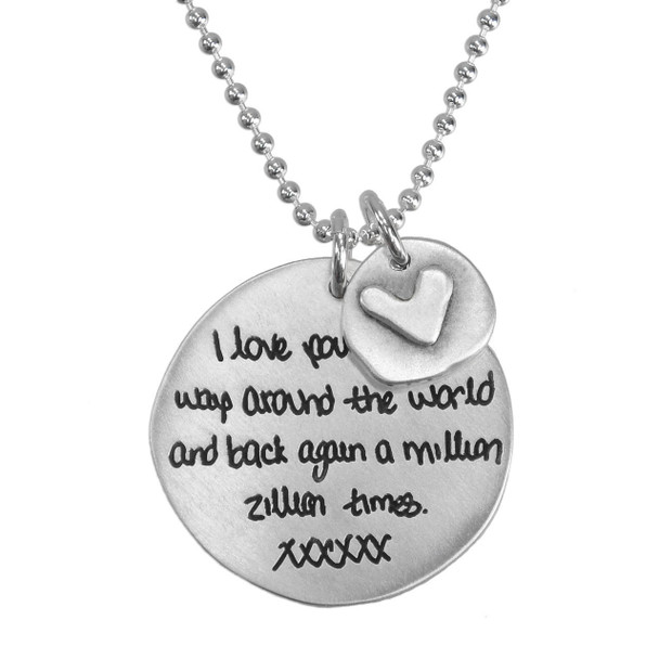 Custom silver handwriting necklace personalized with handwritten love note from spouse, with a silver disc with silver heart hung on a silver ball chain, shown close up on white