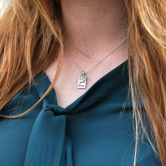 Love you more silver necklace on person