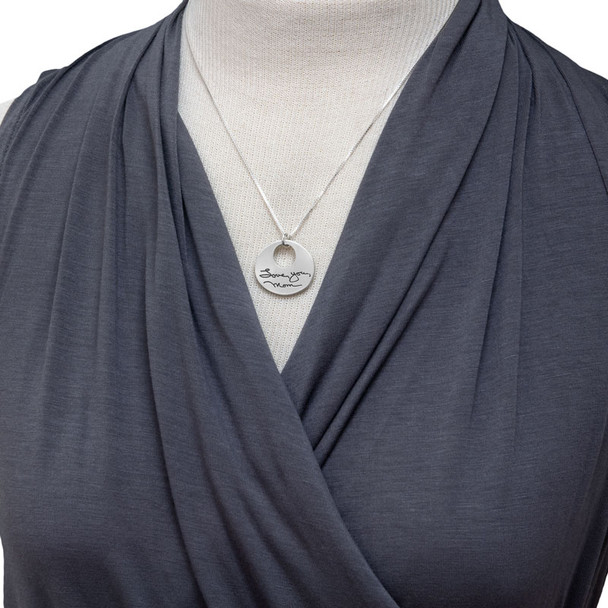 Model wearing custom silver Sculpted Circle Cut Out Handwriting Necklace, personalized with handwritten words "Love You Mom"
