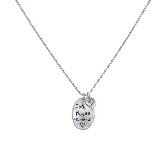Wide view of handmade sterling silver oval custom engraved with kids' signatures - Jenna, Ryan and Matthew- paired with silver disc with raised heart, hung on a silver ball chain.