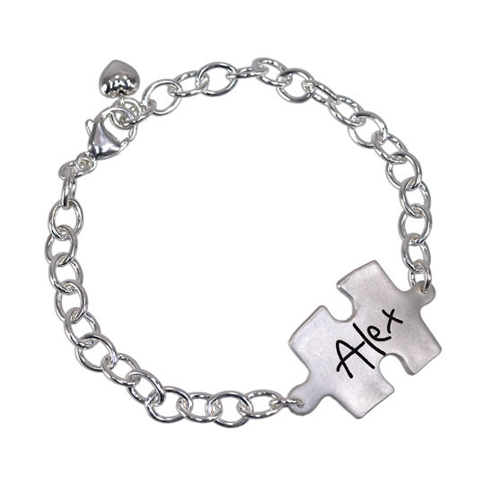 Custom silver puzzle piece handwriting bracelet, personalized with child's signature, shown on white