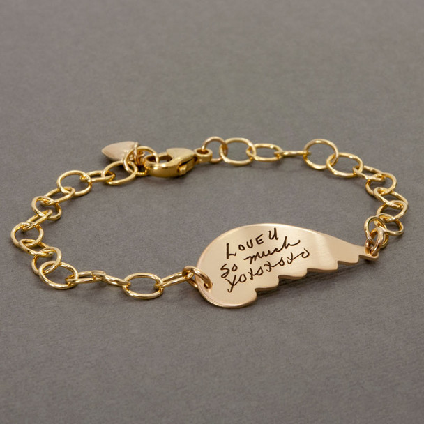 Gold handwriting memorial angel wing bracelet engraved with Mom's actual handwriting, shown from the side