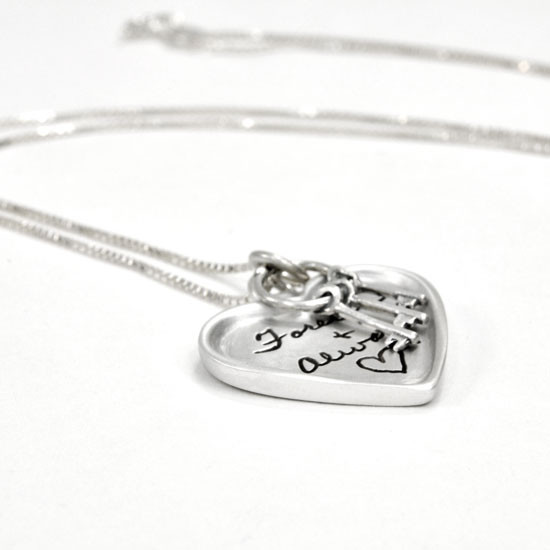 Large silver heart handwriting necklace with keys to your heart, shown close up on white from the side, with Forever and Always engraved on it
