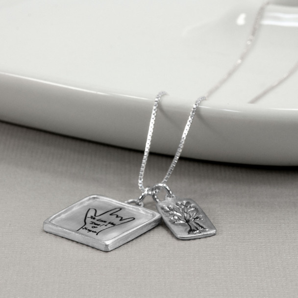 Silver Family Sculpted Raised Edge necklace with handwriting, shown from the side