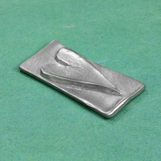 Side view of front of fine pewter pocket charm with a raised heart
