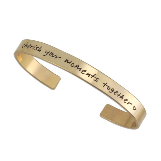 Gold handwriting cuff remembrance bracelet, with passed loved one's actual handwritten note on the outside, shown on white