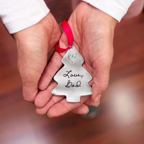 Personalized Memorial Christmas Tree Handwriting Ornament in fine pewter, customized with your loved one's handwritten note, shown in hands