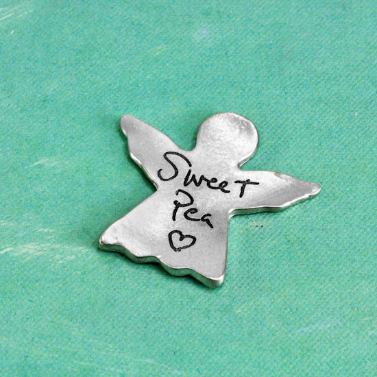 Angel pocket token in fine pewter with custom handwriting, shown from the side