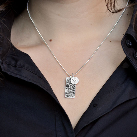 Custom Silver fingerprint necklace, personalized with your loved one's fingerprint, shown on a model