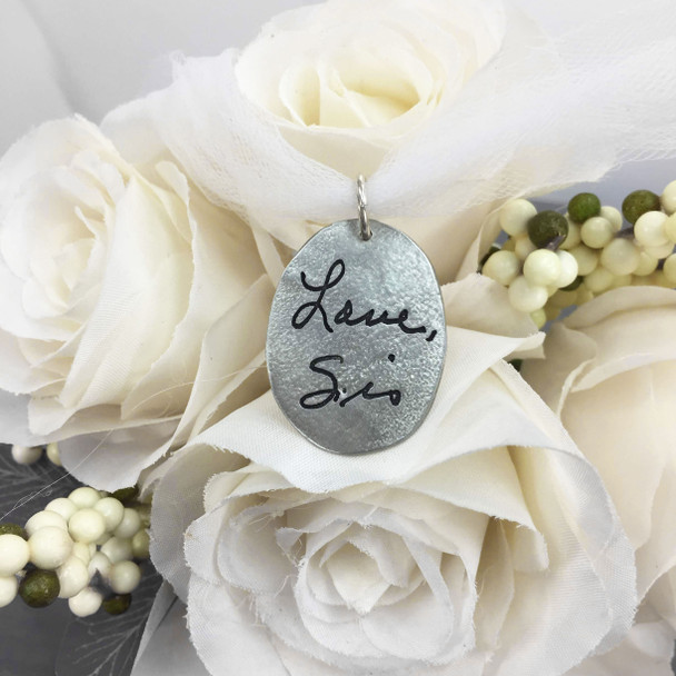 Personalized handwritten note on bouquet charm with cross