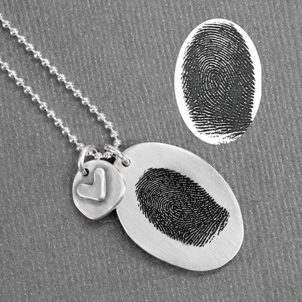 Custom silver fingerprint necklace, with silver heart charm, shown with the fingerprint used to personalized it