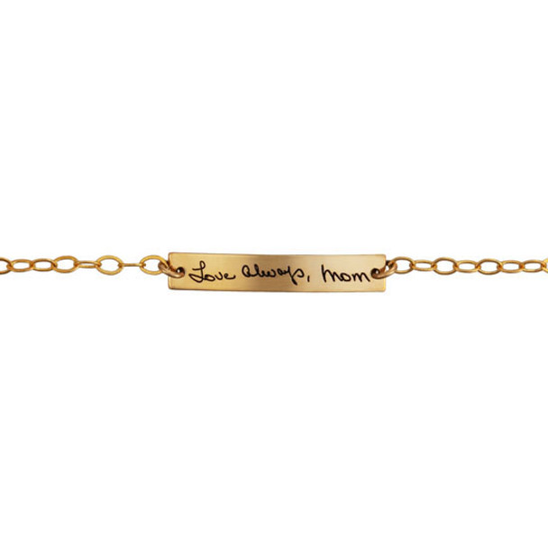 Dainty memorial bracelet with Mom's actual handwritten signature in gold, shown close up on white