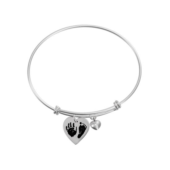 Wide view of custom adjustable silver charm bracelet with silver heart charm personalized with child's actual handprint and footprint engraved on it, shown on white, along with a puffed silver heart charm