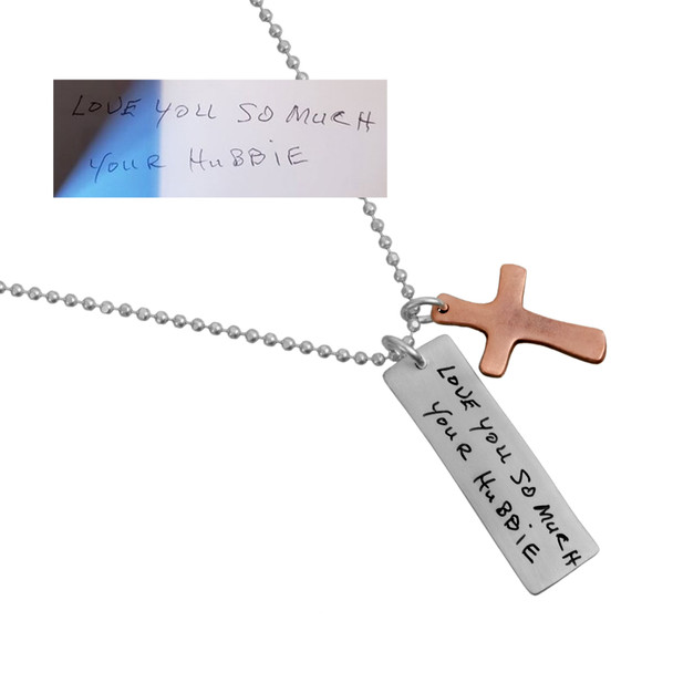 Custom silver handwriting tag with copper cross memorial necklace, shown on white with the original handwriting