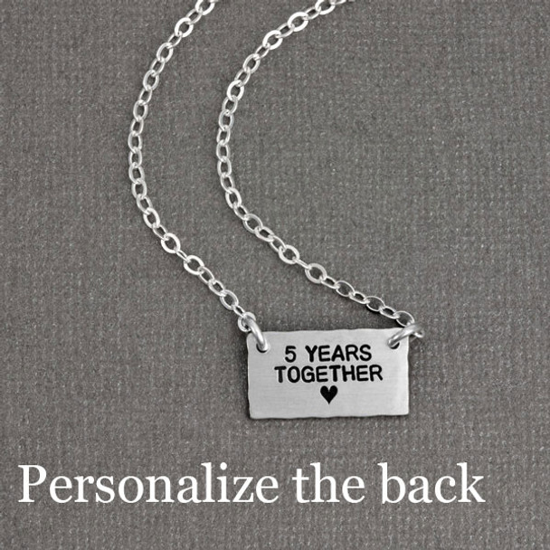 Sterling silver handmade Birds in Love Necklace side view back side on gray 