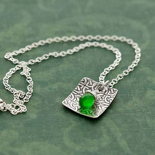 Side view of handmade Celtic Knot with green Briolette Necklace, shown on green
