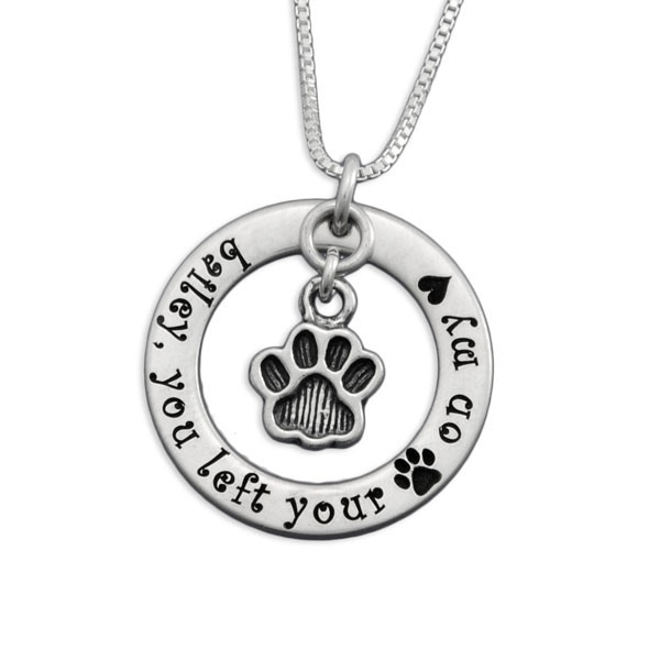Silver circle necklace with Baily you left your paw on my heart, and a silver paw charm hanging within the circle, all on a silver chain (shown close up)