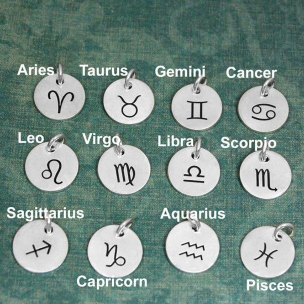 Silver Classic Zodiac Sign Charms, in all the zodiac signs, shown on green