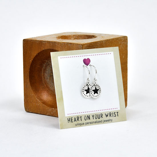 Handmade sterling silver star earrings with dotted border on sterling silver ear wires, shown shown in packaging