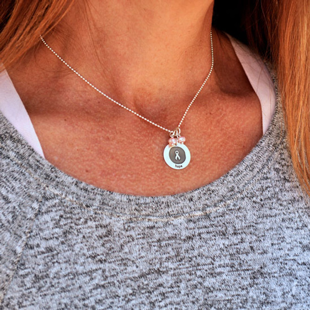 Model wearing silver Etched Awareness Necklace with Pink Stones