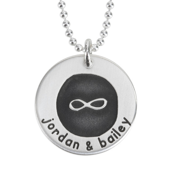 Custom Etched Infinity Forever Love Necklace, personalized with couple's names on the front, shown close up on white