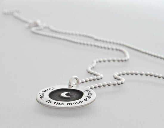 Side view of custom silver Etched Forever Love moon and back necklace