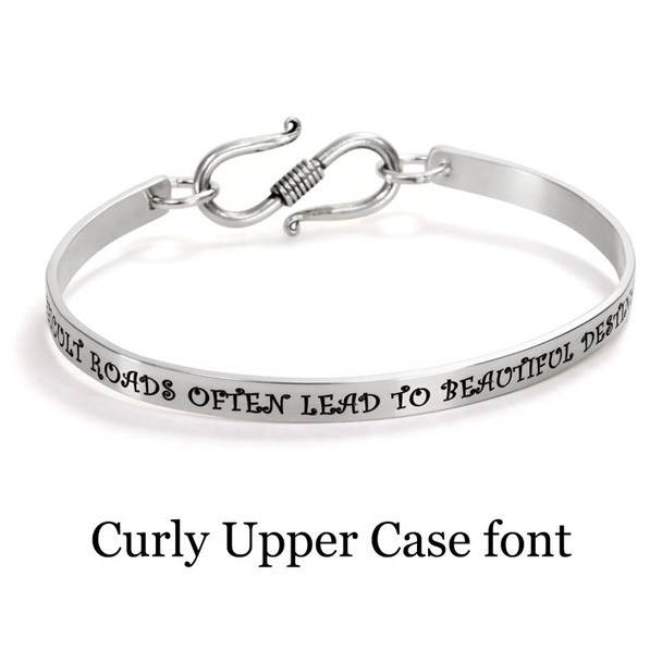 Custom stamped Inspiration Bracelet in Sterling Silver personalized with message in Curly Upper Case font, saying "Difficult roads often lead to beautiful destinations"