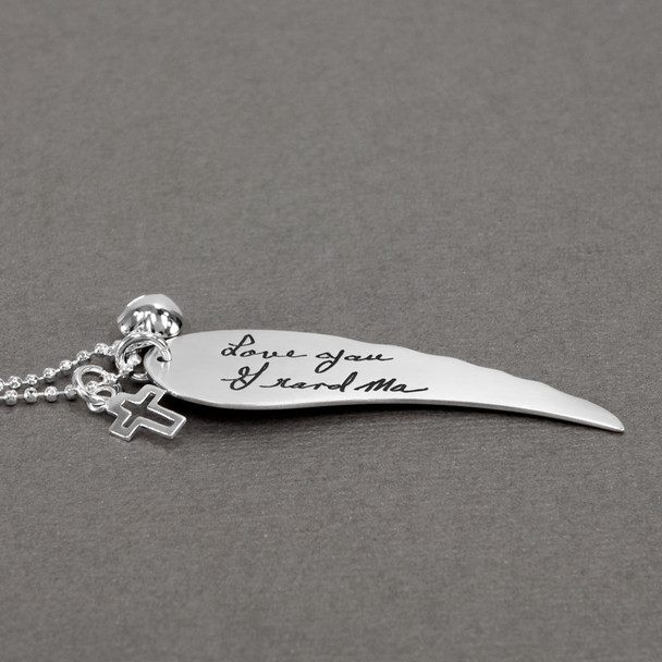 Large Handwriting Memorial Charm Angel Wing in silver, with a silver puffed heart and Sterling Silver Cross with Cut-Out, shown close up from the side