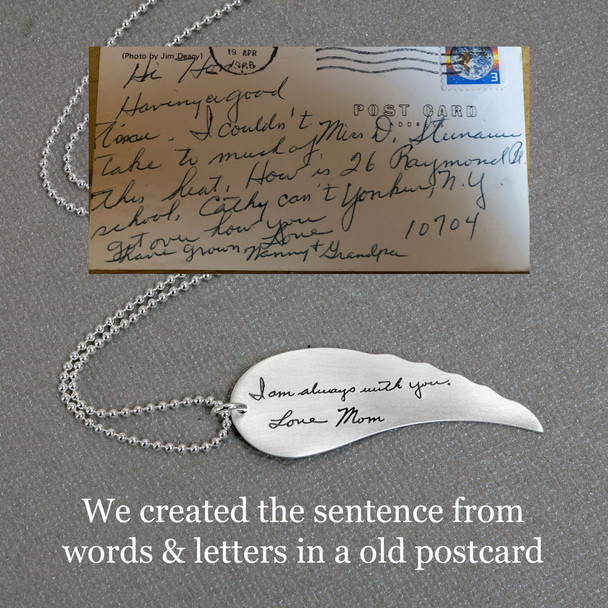Large Handwriting Memorial Charm Angel Wing in silver, shown close up, with the original handwriting used to create it