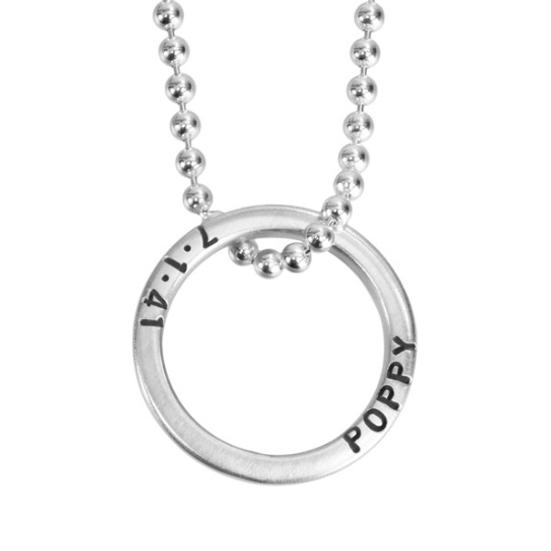 Close up view of custom silver Mini Forever Love Circle Necklace, personalized with Poppy's name and birthdate